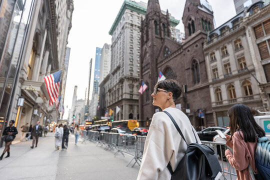 Tourist walking and admiring fifth avenue in manhattan, new york city
