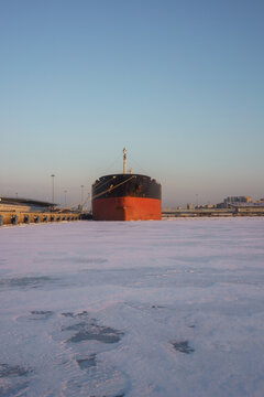 Cargo ship docked in frozen winter port
