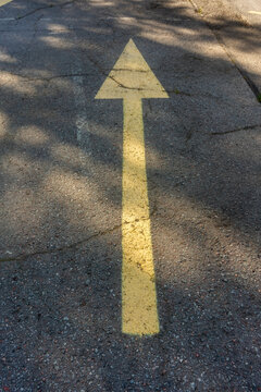 Yellow Arrow Marking on Asphalt Road