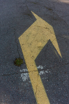 Yellow Arrow Marking on Asphalt