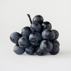 A collection of ripe black grapes beautifully displayed on a white background