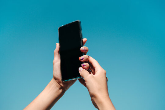 Woman's hands holding phone