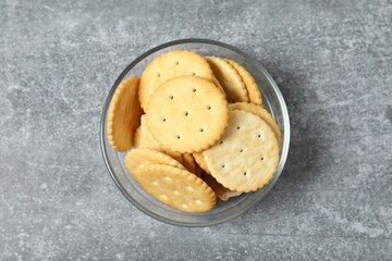 Delicious crispy crackers cookies in a plate on gray background 
