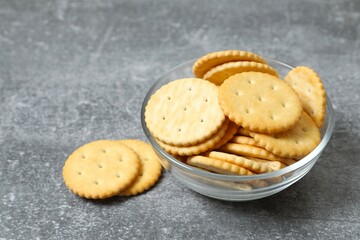 Delicious crispy crackers cookies in a plate on gray background 