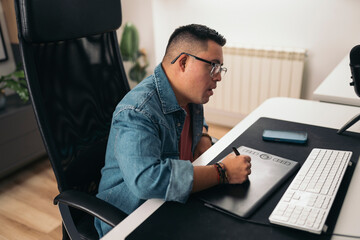 Man with Down syndrome working with digital tablet at desk