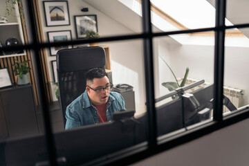 Man with Down syndrome working at desk in modern office