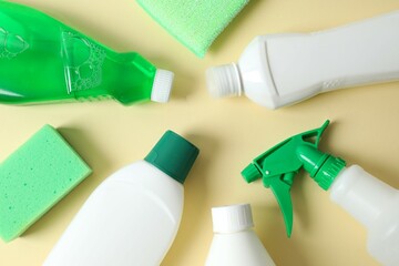 Many different cleaning products on color background, top view