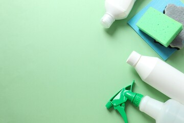 Many different cleaning products on color background, top view