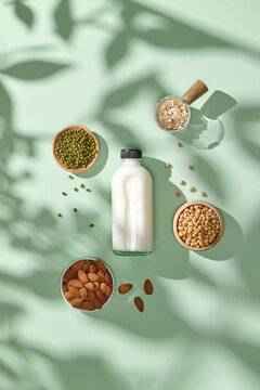 Assorted Nuts and Grains with Milk Bottle on Green Background
