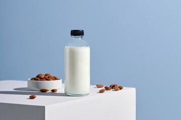 Almond milk in glass with almonds