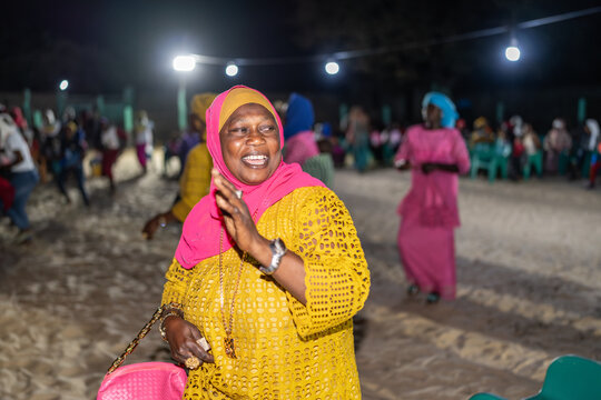 Senegalese woman dancing and clapping at night in senegal, africa