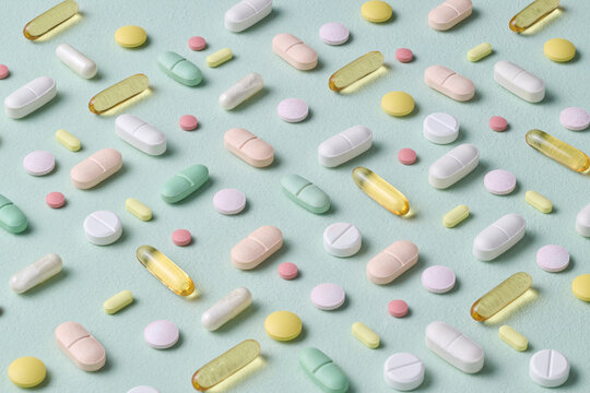 Colorful Assortment of Various Pills on Mint Background