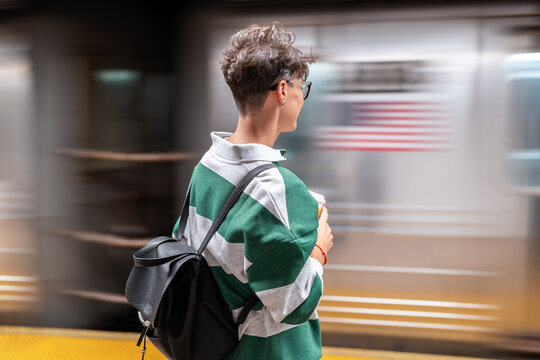 Student waiting for subway train in manhattan, new york