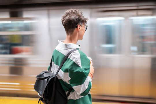 Student waiting for subway train in manhattan, new york