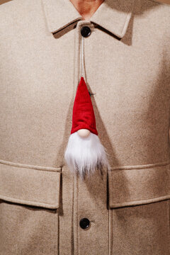 santa claus hanging from the jacket of a man