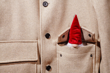 santa claus peeking out from the pocket of his jacket