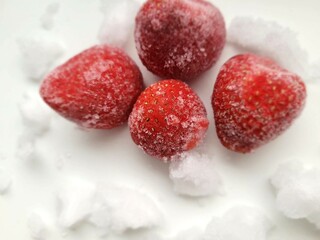 Delicious portion of frozen strawberries and ice pieces.