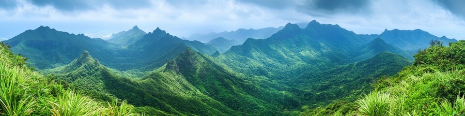 Lush green mountain landscape under a cloudy sky, showcasing natural beauty and tranquility.