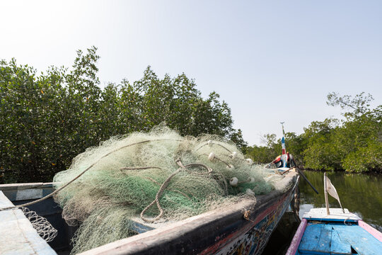 Fishing nets resting on colorful boat in delta saloum, senegal