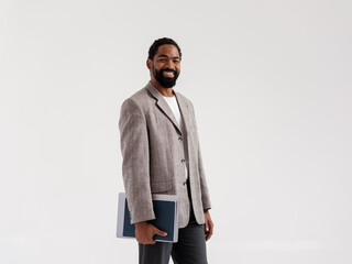 Confident Professional Holding Laptop in Business Attire