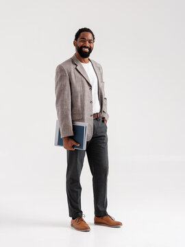 Confident Businessman Holding a Laptop In Front Of White Background