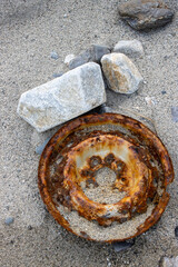Hubcap washed out rusted from the sea, Italy