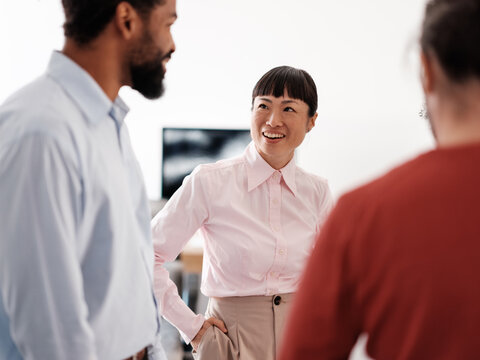 Diverse Group of Professionals Engaged in Friendly Office Discus