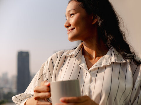 Calm Woman Enjoying Morning Coffee Near City Window View
