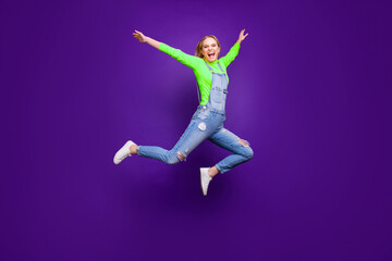 Full size photo of lovely youth raising her hands screaming isolated over purple violet background