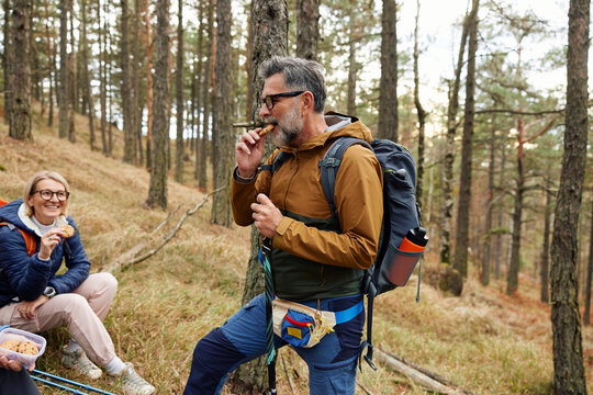 Portrait of a hiker enjoying a snack in the woods