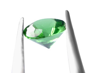 Tweezers with shiny green gemstone isolated on white