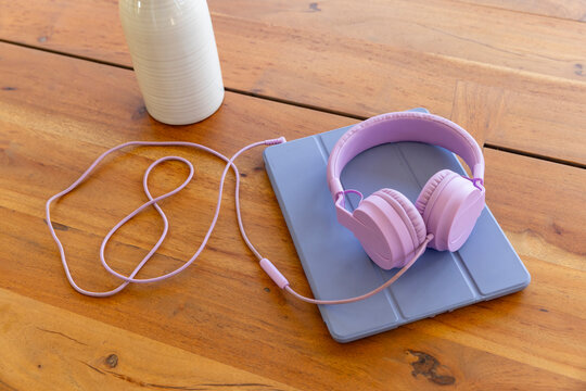 Tablet computer  headphones on table 