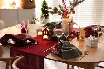 Christmas table setting with stylish dishware and festive decor indoors