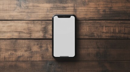Smartphone with blank screen on wooden surface.