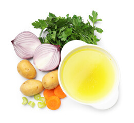 Tasty chicken bouillon in bowl and ingredients isolated on white, top view