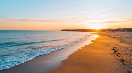 A serene beach at sunset, with golden sands and gentle waves lapping at the shore, under a colorful sky.