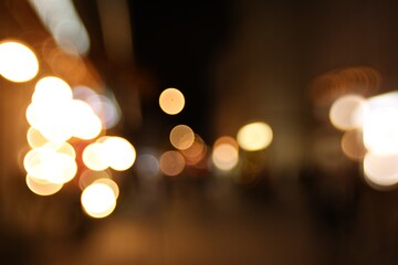 Fototapeta premium Blurred view of city street at night. Bokeh effect