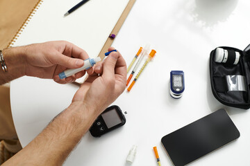 Young man managing diabetes daily at home in a modern apartment