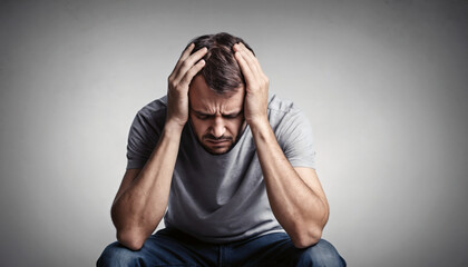 Depressed man with head in hands. Mental health concept.