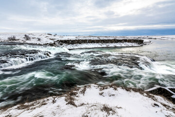 Fototapeta premium long exposure ice winter Iceland water running waterfall
