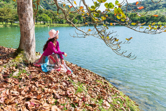 Woman Enjoys Peaceful Autumn Day by Lake Landscape