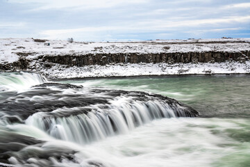 Obraz premium long exposure ice winter Iceland water running waterfall