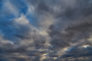 Blue winter sky with gray-white clouds after a snowfall.