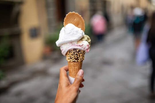 ugc of woman showing a large ice cream in a village in italy