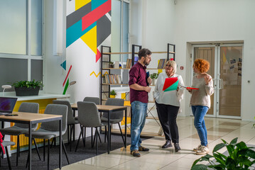 Teachers communicate with each other in the school interior