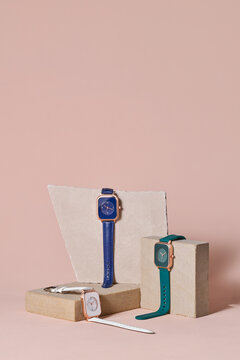 Elegant Modern Watches on Minimalist Display with Pastel Background