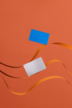 Creative Abstract Composition With Blue And White Cards On Orang