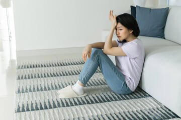 Stressed Woman Sitting on Floor in Modern Living Room