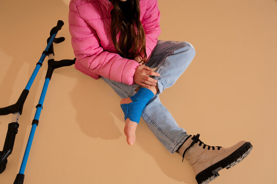 Girl Adjusting Leg Bandage
