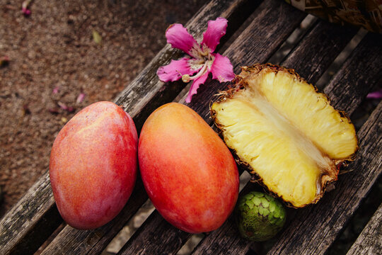 Fresh tropical fruits displayed on a wooden table